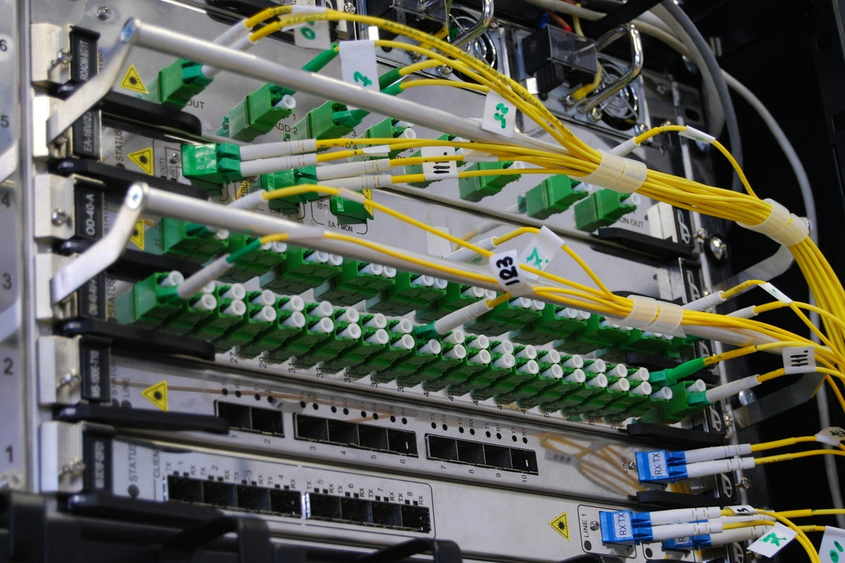 Live yellow fiber jumpers on a DWDM multiplexer patch panel