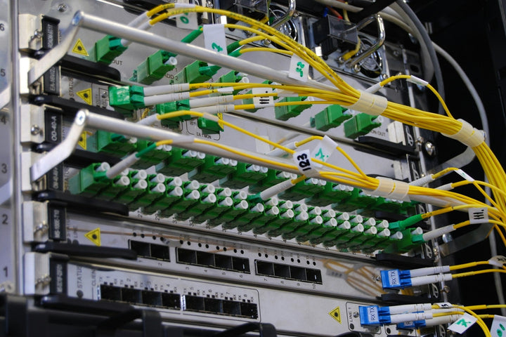 Live yellow fiber jumpers on a DWDM multiplexer patch panel
